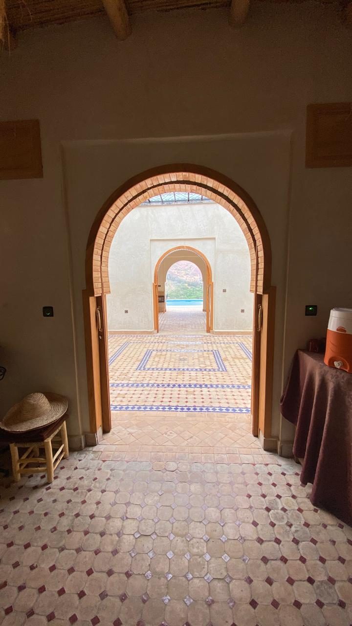 Enfilade de portes en arc ouvrant depuis l'intérieur sur la terrasse de la piscine